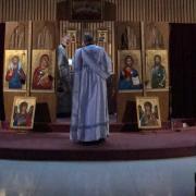 Deacon Nicholas stands before the iconostasis.