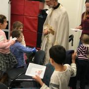 Fr. Geoff blessing a child.