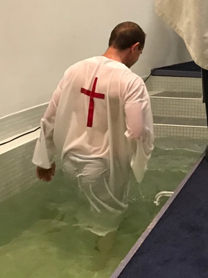 Candidate emerging from the waters of baptism