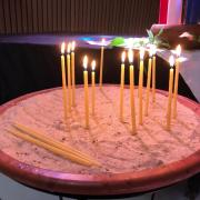 Candles in sandbox lighting the world with prayers